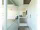 White screened door leading into a carport at 672 Circlewood Dr # V9, Venice, FL 34293