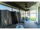 Screened porch with ceiling fan and patio furniture at 672 Circlewood Dr # V9, Venice, FL 34293