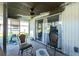 Screened porch with ceiling fan and patio furniture at 672 Circlewood Dr # V9, Venice, FL 34293