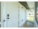 White door entry to screened porch with concrete floor at 672 Circlewood Dr # V9, Venice, FL 34293