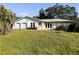 Single-story house with a two-car garage and large front yard at 7140 Teaberry St, Englewood, FL 34224