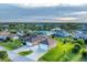 Aerial view of a house with a large yard and two-car garage at 7257 Bridgeport Ln, Englewood, FL 34224