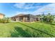 Landscaped backyard with screened-in pool area at 7257 Bridgeport Ln, Englewood, FL 34224