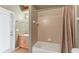 Clean bathroom with a shower/tub combo and wood vanity at 7257 Bridgeport Ln, Englewood, FL 34224