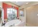 Spa-like bathroom with a large soaking tub and separate shower at 7257 Bridgeport Ln, Englewood, FL 34224