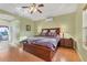 Spacious bedroom with wood flooring and a large bed at 7257 Bridgeport Ln, Englewood, FL 34224