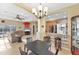 Open dining area with a dark wood table and kitchen view at 7257 Bridgeport Ln, Englewood, FL 34224