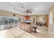 Spacious living room with leather couches, a flat-screen TV, and pool access at 7257 Bridgeport Ln, Englewood, FL 34224