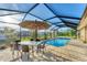 Relaxing pool area with patio table and chairs at 7257 Bridgeport Ln, Englewood, FL 34224