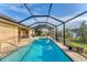 Spacious pool and patio area with a screened enclosure at 7257 Bridgeport Ln, Englewood, FL 34224