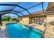 Large screened-in pool with plenty of space for relaxation at 7257 Bridgeport Ln, Englewood, FL 34224