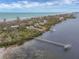 Aerial view of waterfront home with private dock at 7475 Manasota Key Rd, Englewood, FL 34223
