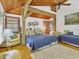 Bedroom with king-size bed, twin bed, and wood-beamed ceiling at 7475 Manasota Key Rd, Englewood, FL 34223