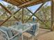Covered deck with seating area and fire pit, offering scenic views at 7475 Manasota Key Rd, Englewood, FL 34223