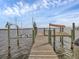 Private wooden dock with boat lift at 7475 Manasota Key Rd, Englewood, FL 34223