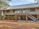 Charming raised beach home with a metal roof, wood siding, and a spacious deck for enjoying the coastal views at 7475 Manasota Key Rd, Englewood, FL 34223