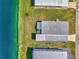 An aerial view showcasing a home's roofline and canal-side location at 812 Seabrooke Dr, Englewood, FL 34223