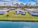 Aerial view of waterfront property with lush landscaping at 812 Seabrooke Dr, Englewood, FL 34223