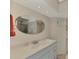 Bathroom with oval mirror and vanity at 812 Seabrooke Dr, Englewood, FL 34223