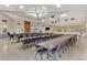 Spacious community room with tables, chairs, and a stage at 812 Seabrooke Dr, Englewood, FL 34223