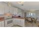 Updated kitchen with white cabinets and appliances at 812 Seabrooke Dr, Englewood, FL 34223
