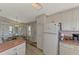 Kitchen with island and view into dining area at 812 Seabrooke Dr, Englewood, FL 34223