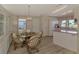 Bright kitchen and dining area with updated flooring and water views at 812 Seabrooke Dr, Englewood, FL 34223