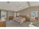 Bright main bedroom with a king-size bed and two windows at 812 Seabrooke Dr, Englewood, FL 34223