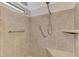 Walk-in shower with tiled walls, seat, and grab bars at 812 Seabrooke Dr, Englewood, FL 34223