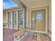 Inviting front entry with decorative screen door and bench at 8224 Lakeside Dr, Englewood, FL 34224