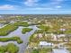 Aerial view of waterfront home and surrounding neighborhood at 900 Oxford Dr, Englewood, FL 34223