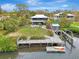 Waterfront home showcasing expansive backyard, dock, and relaxing water views at 900 Oxford Dr, Englewood, FL 34223