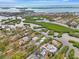 Wide aerial view of property showing home, canal, and neighborhood at 900 Oxford Dr, Englewood, FL 34223