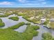 Aerial view showcasing waterfront property and lush landscaping at 900 Oxford Dr, Englewood, FL 34223