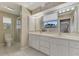 Double vanity bathroom with a large mirror and a walk-in shower at 900 Oxford Dr, Englewood, FL 34223