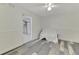 Bright bedroom with wood-look floors and access to storage at 900 Oxford Dr, Englewood, FL 34223