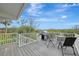Deck with grill and seating, offering picturesque water views at 900 Oxford Dr, Englewood, FL 34223
