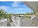 Elevated deck with grill and seating, overlooking the water at 900 Oxford Dr, Englewood, FL 34223
