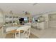 Bright dining area with white table and chairs, near kitchen and living room at 900 Oxford Dr, Englewood, FL 34223