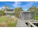 Wooden walkway to the waterfront and a storage shed at 900 Oxford Dr, Englewood, FL 34223
