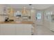 Modern kitchen with white cabinets, butcher block countertops, and stylish lighting at 900 Oxford Dr, Englewood, FL 34223
