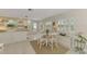 Kitchen features white cabinets, a butcher block island, and a breakfast nook at 900 Oxford Dr, Englewood, FL 34223