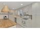 Modern kitchen with white cabinets, butcher block island, and stainless steel appliances at 900 Oxford Dr, Englewood, FL 34223