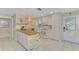 Bright kitchen with white cabinets, butcher block island and modern appliances at 900 Oxford Dr, Englewood, FL 34223