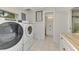 Laundry room with washer, dryer, and access to bathroom at 900 Oxford Dr, Englewood, FL 34223