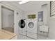 Laundry room with washer, dryer, and utility sink at 900 Oxford Dr, Englewood, FL 34223