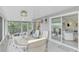 Relaxing screened porch with views of the living area and outdoors at 900 Oxford Dr, Englewood, FL 34223