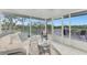 Comfortable screened porch with seating area and tranquil water views at 900 Oxford Dr, Englewood, FL 34223