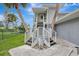 White wooden staircase with nautical statue leading to a home entrance at 900 Oxford Dr, Englewood, FL 34223