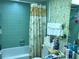 Clean bathroom with tub and floral-patterned walls at 914 E 2Nd St, Englewood, FL 34223